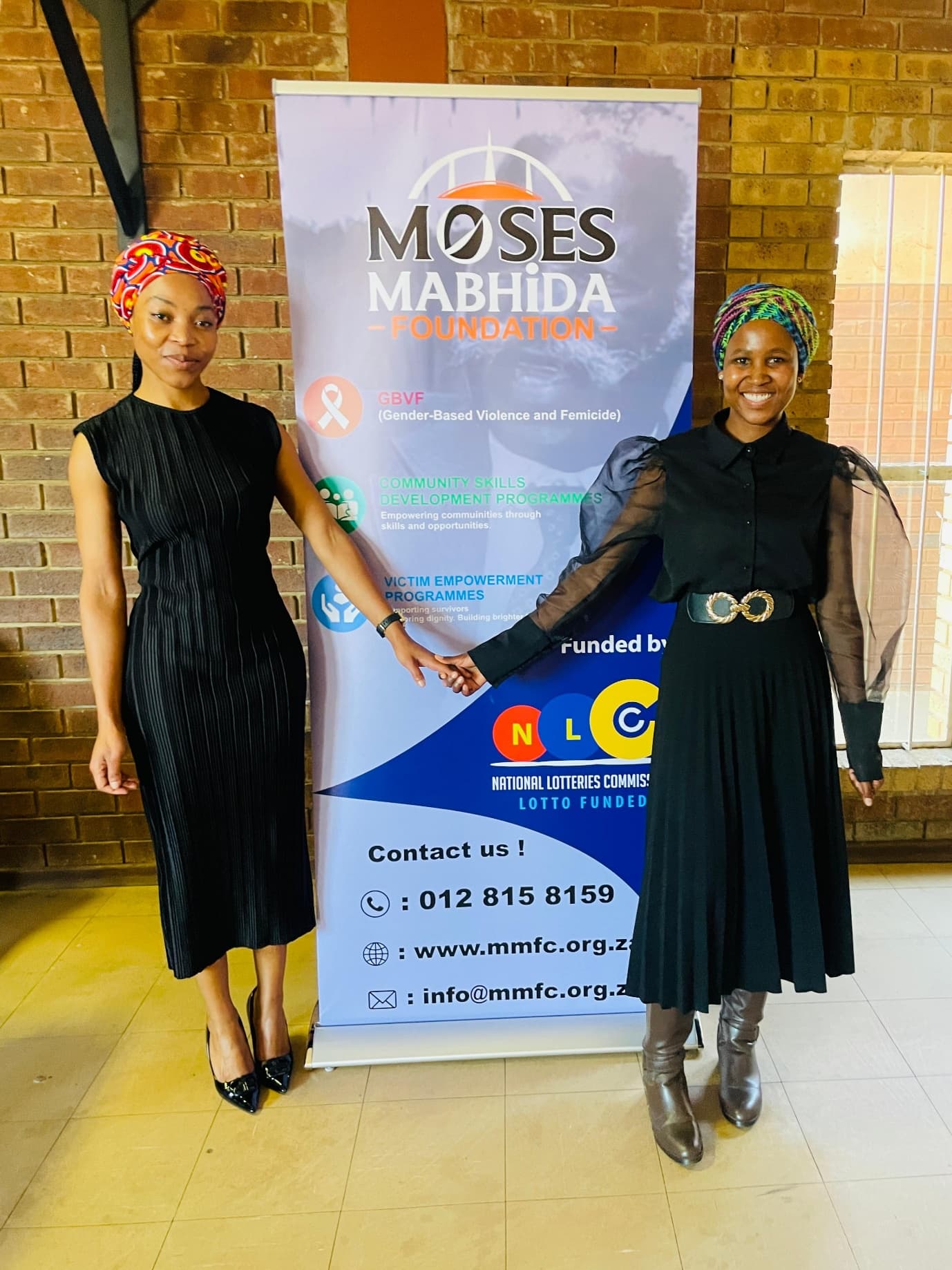 MMF staff beside the Foundation banner at a community event