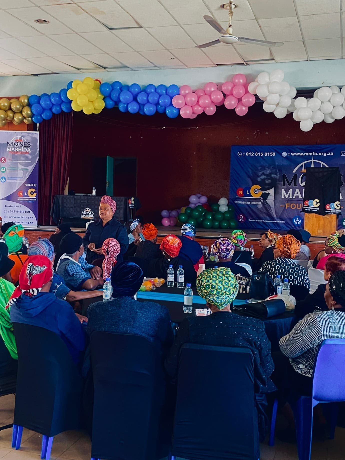 An MMF facilitator speaking to guests at the Women's Day celebration