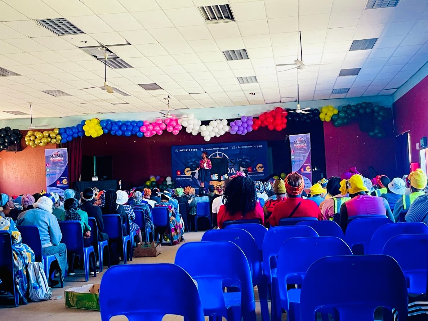 A speaker addressing the Women's Day celebration from the stage