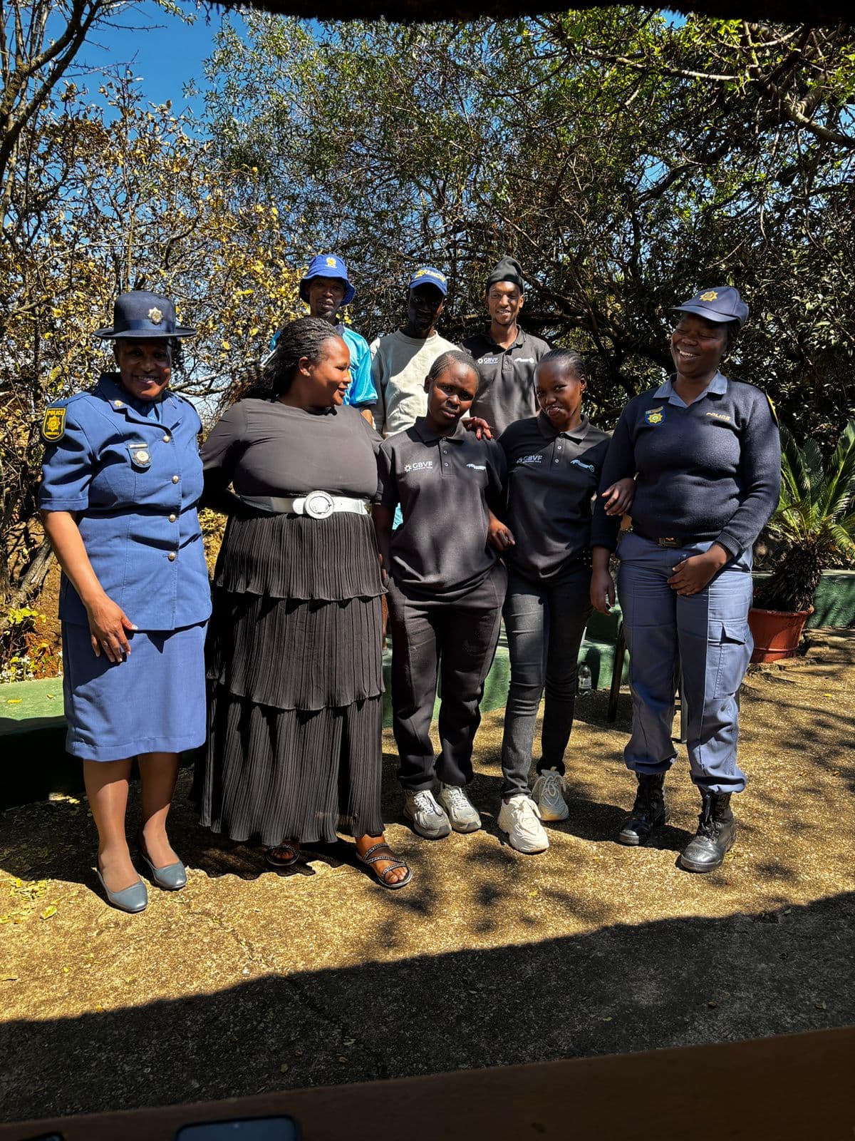 MMF team members standing with SAPS officers at a police officer's memorial service